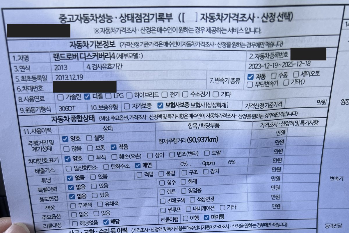 2013년식 랜드로버 디스커버리4 중고자동차 성능·상태점검기록부 첫 면을 손에 들고 찍은 사진